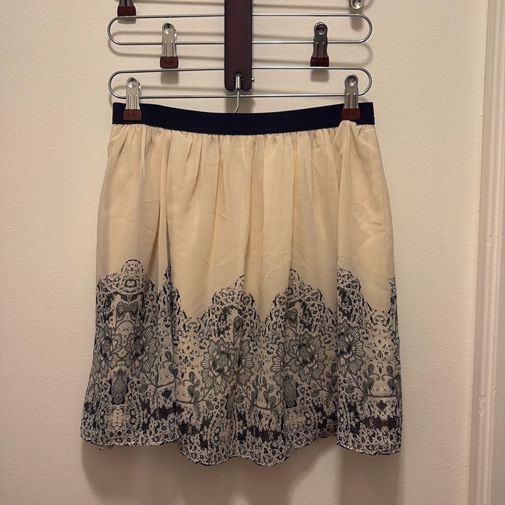 American Eagle brand miniskirt, cream with black lace print